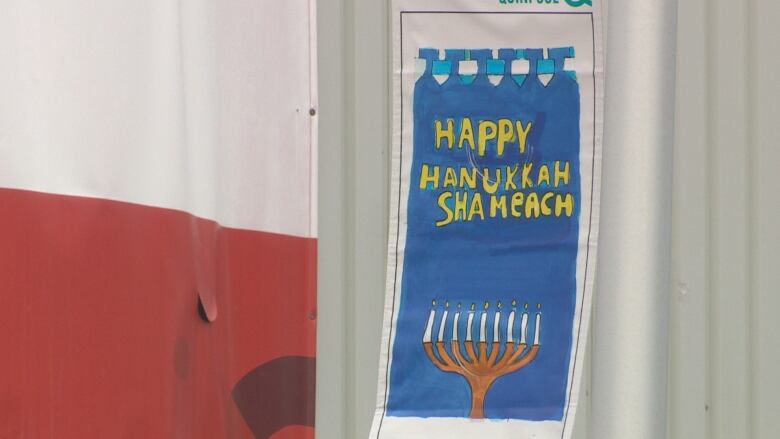 A sign reading Happy Kwanza Shameach