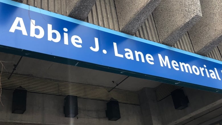 Sign saying Abbie J. Lane Memorial Building with white letters on a blue background