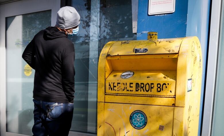 A man waits to enter a supervised consumption site.