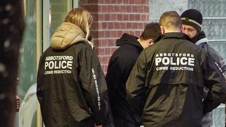 people wearing jackets that say abbotsford police crime reduction