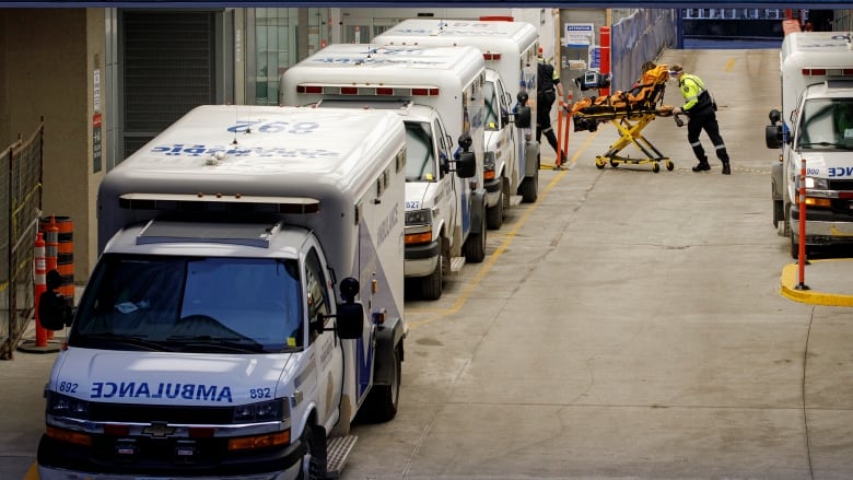 Ambulance paramedics unload patients at the emergency department of Mt. Sinai Hospital, in downtown Toronto, on Jan. 4, 2022. 