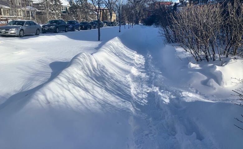 Sidewalk covered in snow.