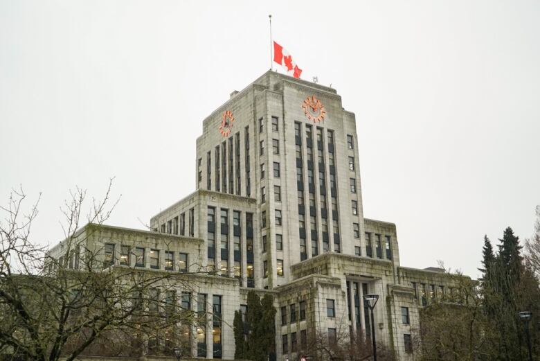 Vancouver City Hall with a flag lowered at half-mast.