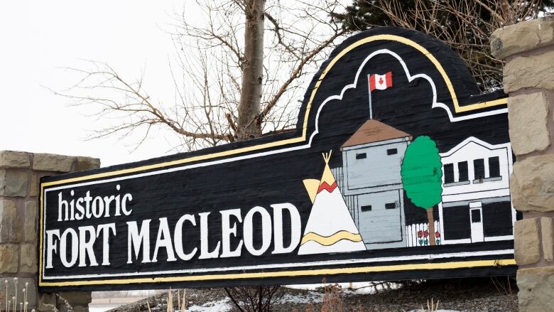 A wooden sign says Fort Macleod in old-timey letters