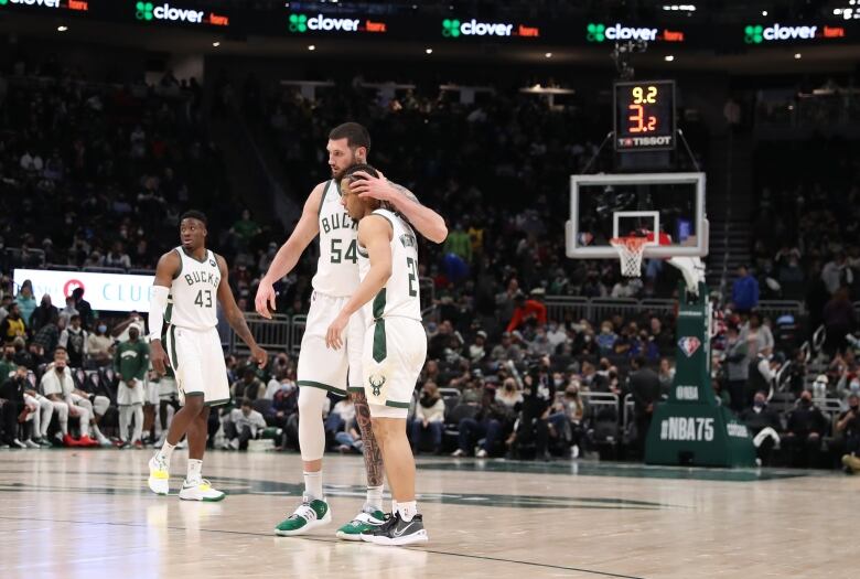 Two Milwaukee Bucks players on a basketball court