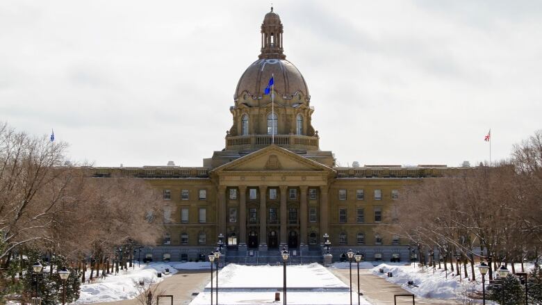 A legislature building is seen during the winter time.