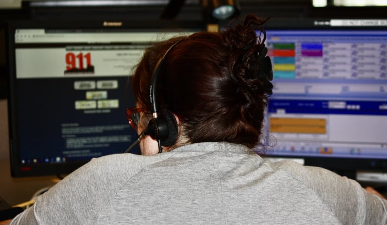 A 911 operator takes calls at her desk in Toronto Police's 911 communication centre.