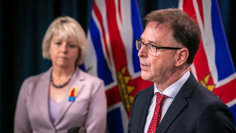 B.C. Health Minister Adrian Dix is pictured at a news conference on Oct. 5, 2021. Provincial Health Officer Dr. Bonnie Henry is pictured at right.