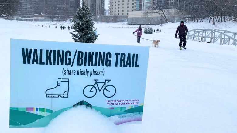 People skate and ski on the river trail.