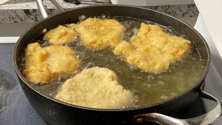 dough frying in a pan