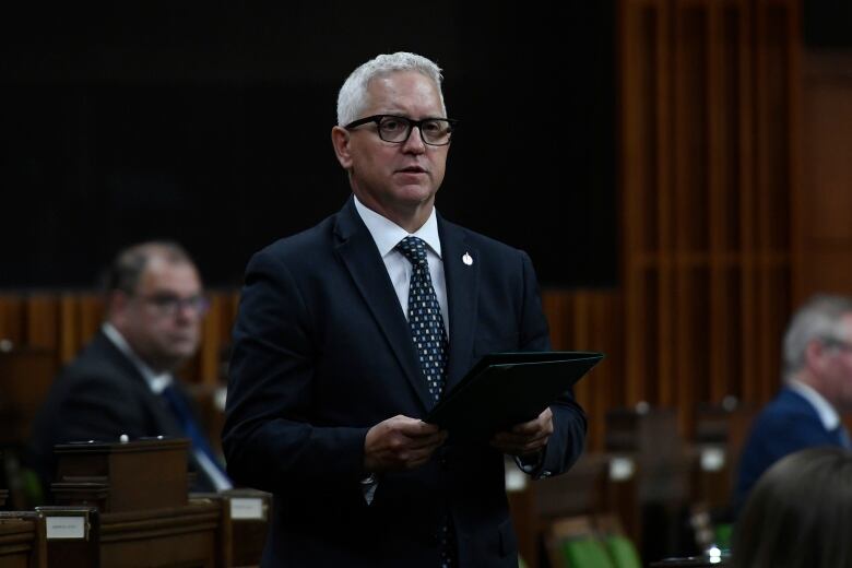 Conservative MP Gary Vidal, wearing a dark suit, glasses and a tie, stands in the House of Commons.