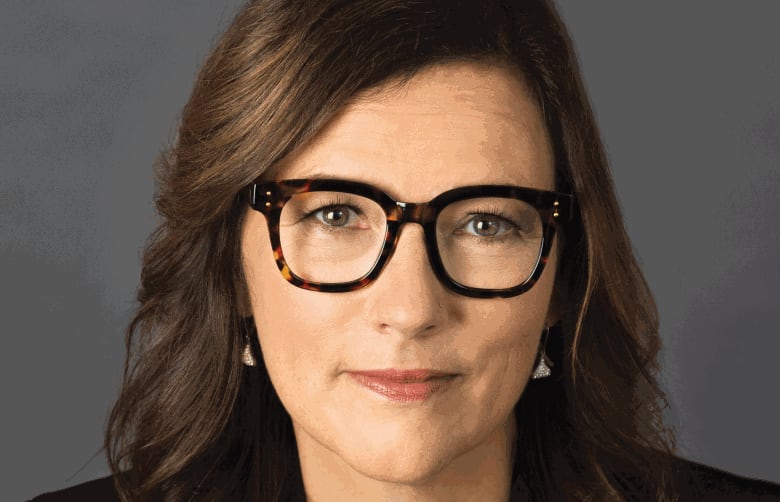 A woman looks into the camera for a headshot photo.