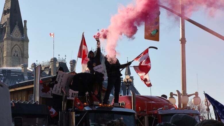 Protesters fire off pink smoke on Parliament Hill during their occupation of Ottawa on Feb. 5, 2022.