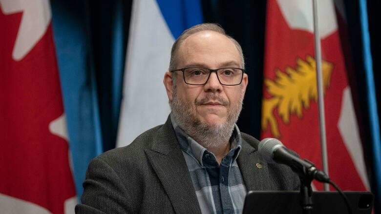 man speaking at city hall