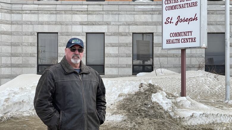 A man standing in front of some snow