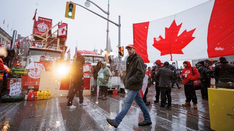 A protester walks through an encampment near Parliament Hill, in Ottawa, shortly before being arrested on Feb. 17, 2022.