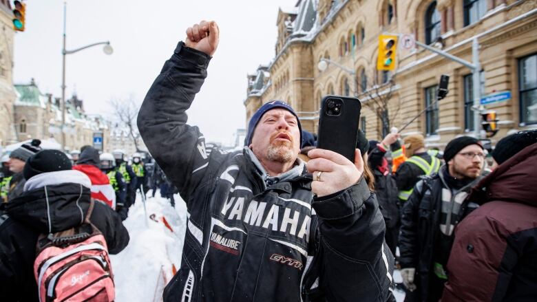 Police enforce an injunction against protesters, some who have been camped in their trucks near Parliament Hill for weeks, on Feb. 19, 2022.