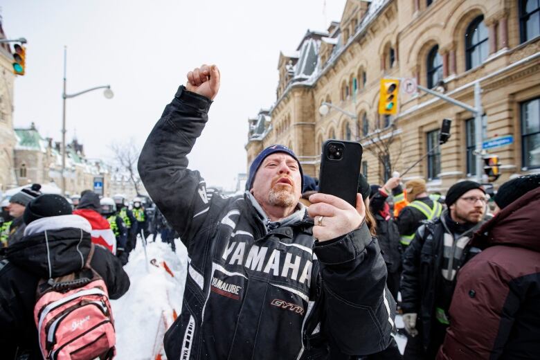 Police enforce an injunction against protesters, some who have been camped in their trucks near Parliament Hill for weeks, on Feb. 19, 2022.