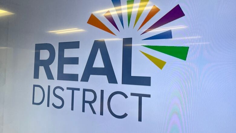 A sign says 'REAL district.'