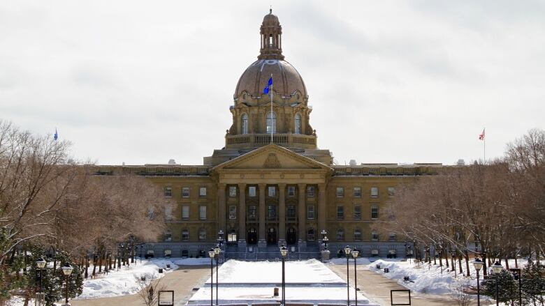 The Alberta legislature, a large domed building, pictured in winter.