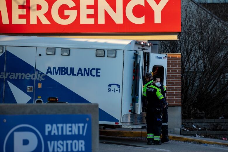 Photograph of ambulance paramedics unloading patients outside a Toronto hospital.