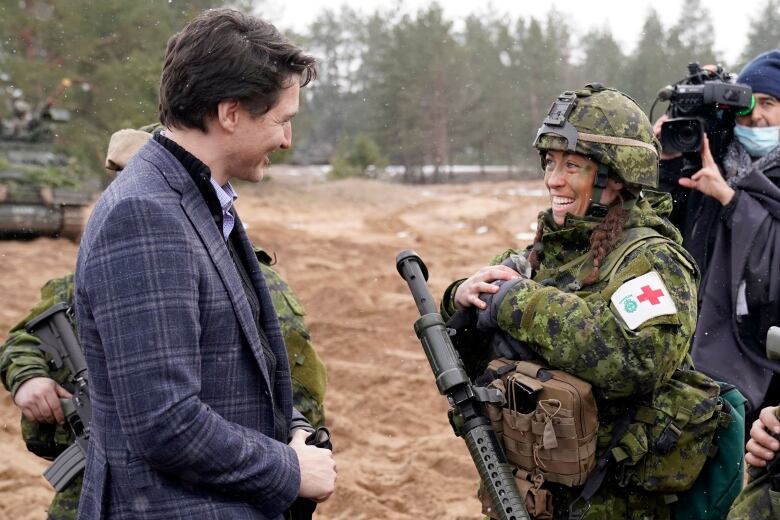 Prime Minister Justin Trudeau talks with a Canadian soldier during his visit to Adazi Military base in Kadaga, Latvia on Tuesday, March. 8, 2022.