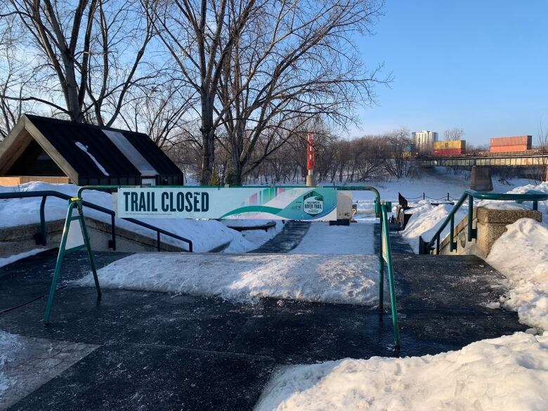 A sign indicates a trail is closed.