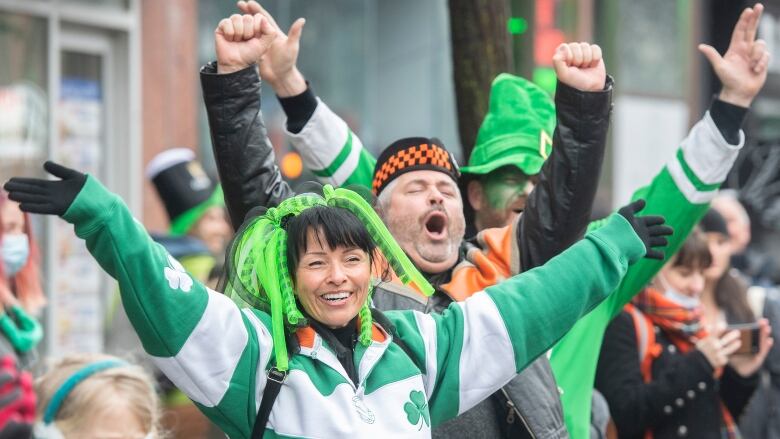 A woman and man dressed in green cheer at the St. Patricks Day parade in Montreal.