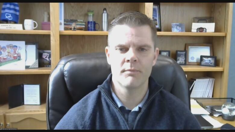 Man in home office, shown on Zoom screen.