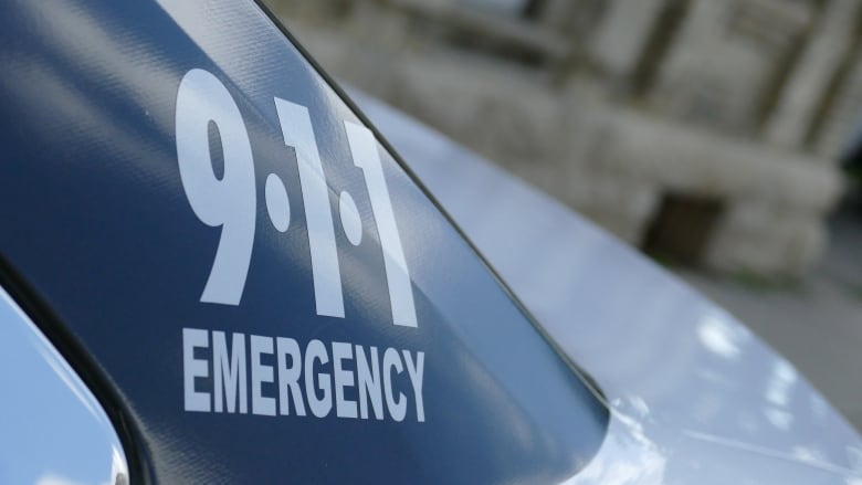 Part of a police car is pictured, showing the words '911 - emergency.'