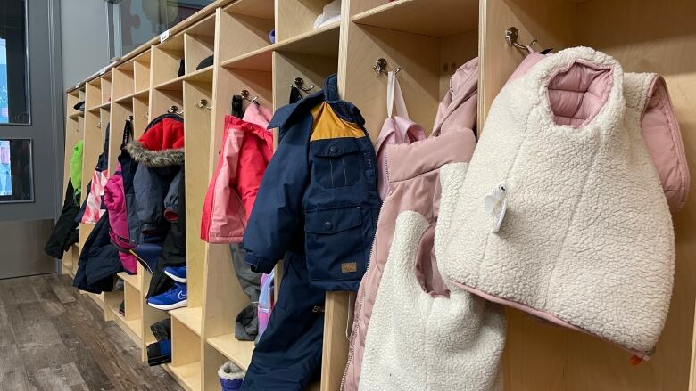 Children's boots and coats in cubbies.