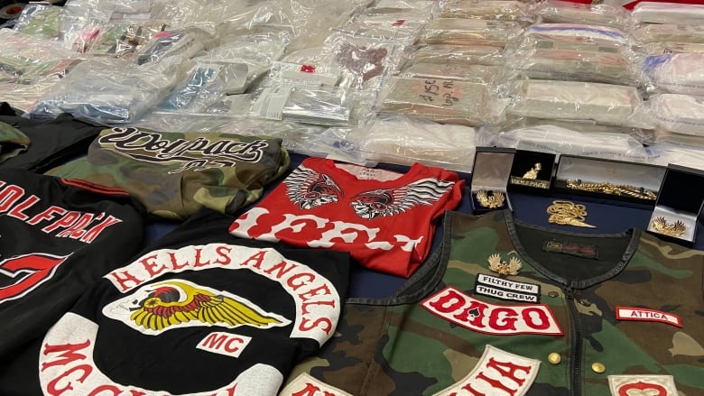 Hells Angels patches and paraphernalia are displayed by Manitoba RCMP in March 2023, after arrests and seizure of more than $70 million in illicit drugs.