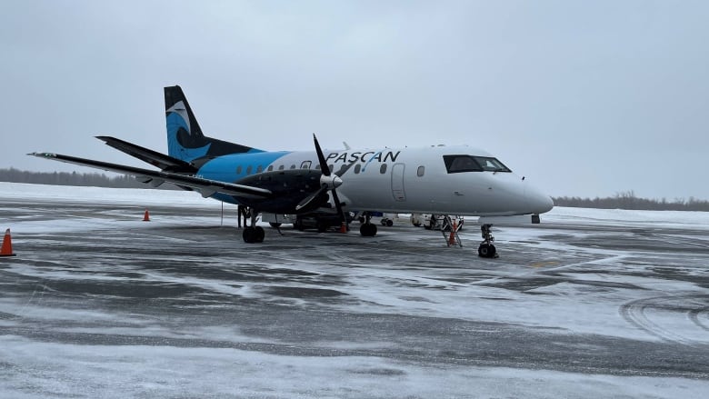 An airplane sits on a runway.