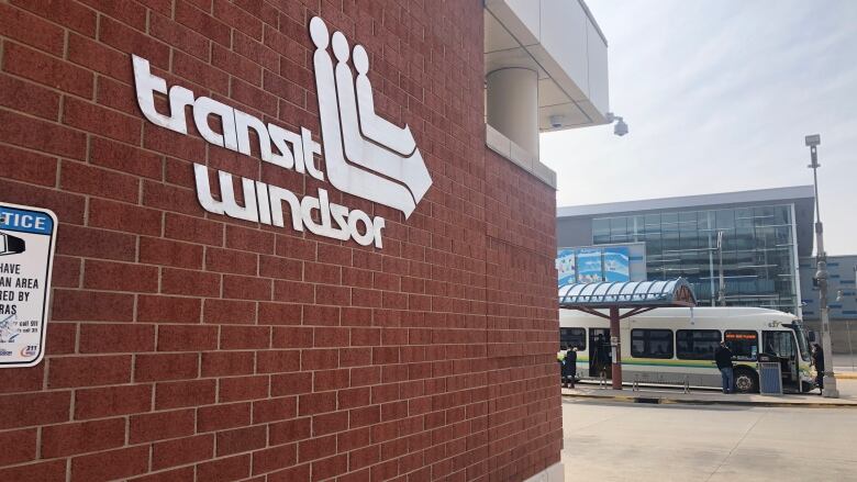 A sign read Transit Windsor with a bus in the back. 