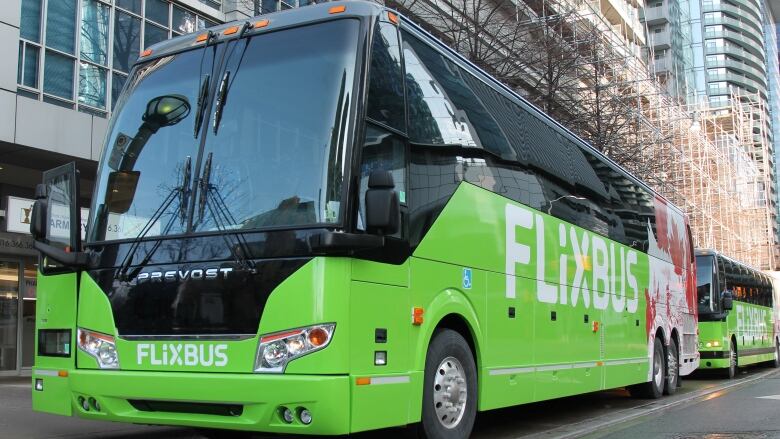 A view of a charter bus, painted bright green with a logo that says 