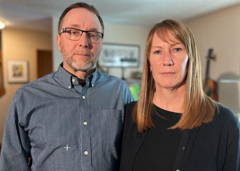 A man and a woman stand beside each other in a home.