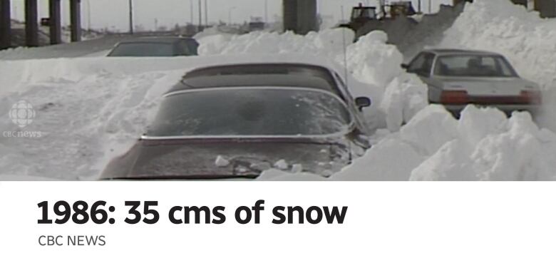 The aftermath of a snowstorm shows mounds of snow and the rooftops of cars.