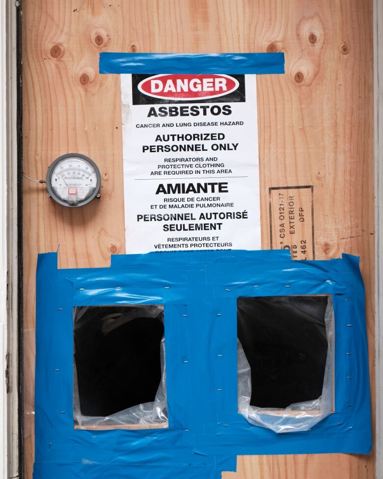 Two doors with the words 'DANGER Asbestos'.