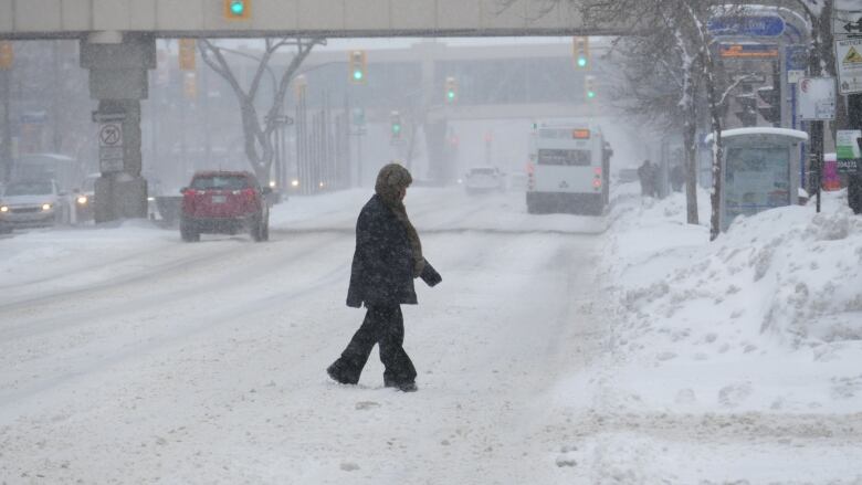 A man walking on a snowy road.