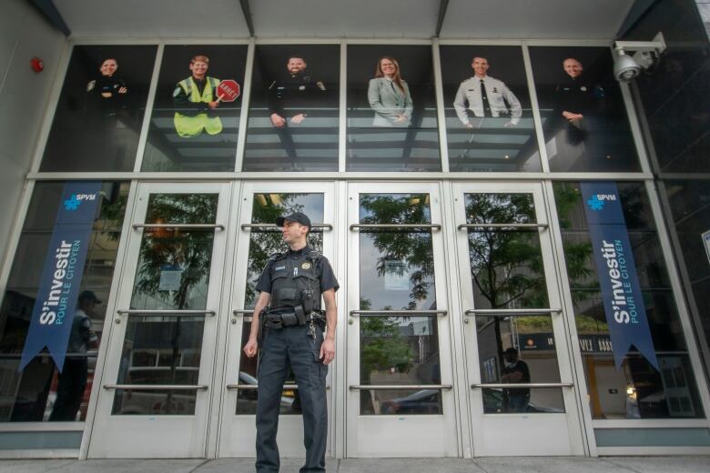 A police officer in front of a building.