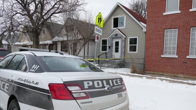 A police car sits outside a home.