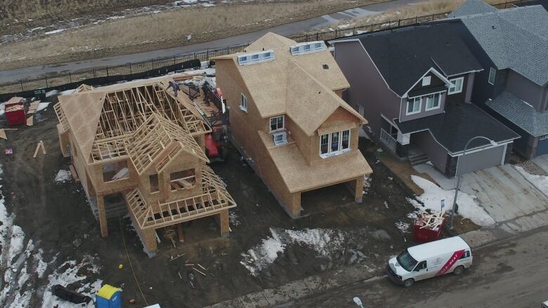 Multiple houses are shown in various stages of construction in the east end of Regina.