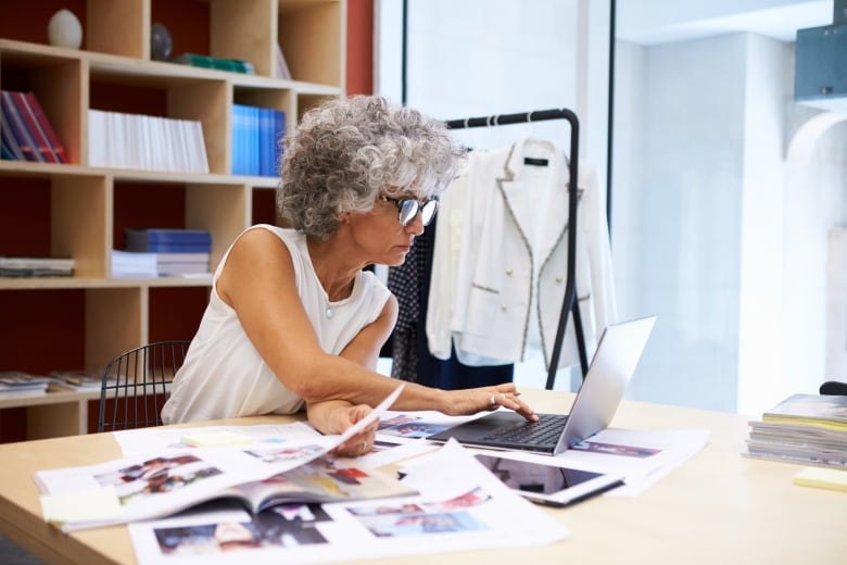 A woman works on a computer in an office. 