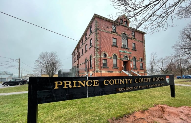 A three-storey square brick building with a sign reading Prince County Court House.