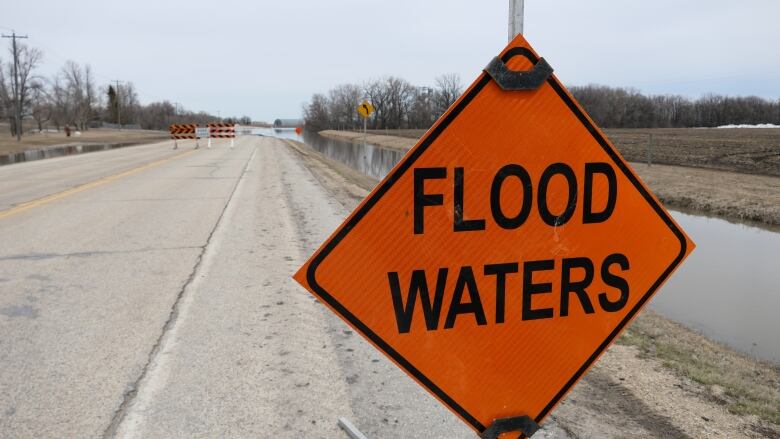 Roads with orange construction sign in front that reads 