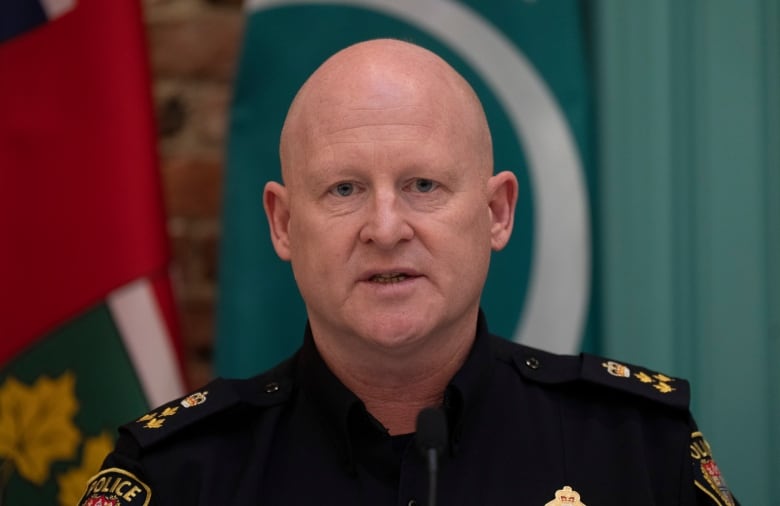 Close up shot of a police officer talking to a microphone.