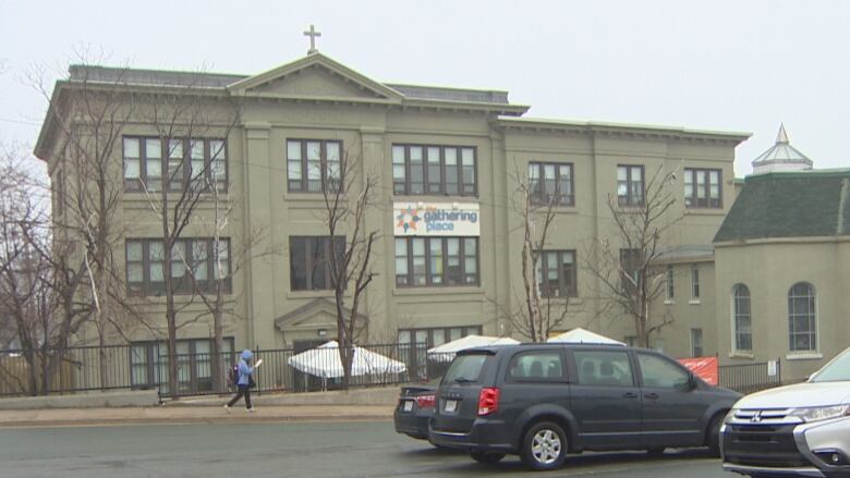 A large stone building with a banner that says 