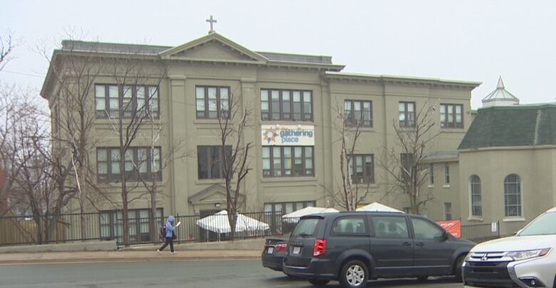 A large stone building with a banner that says 