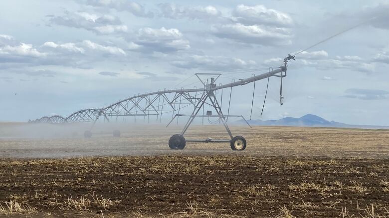 An irrigator rests in a field.