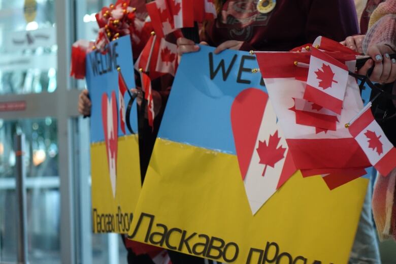 Yellow and blue signs and small Canadian flags.